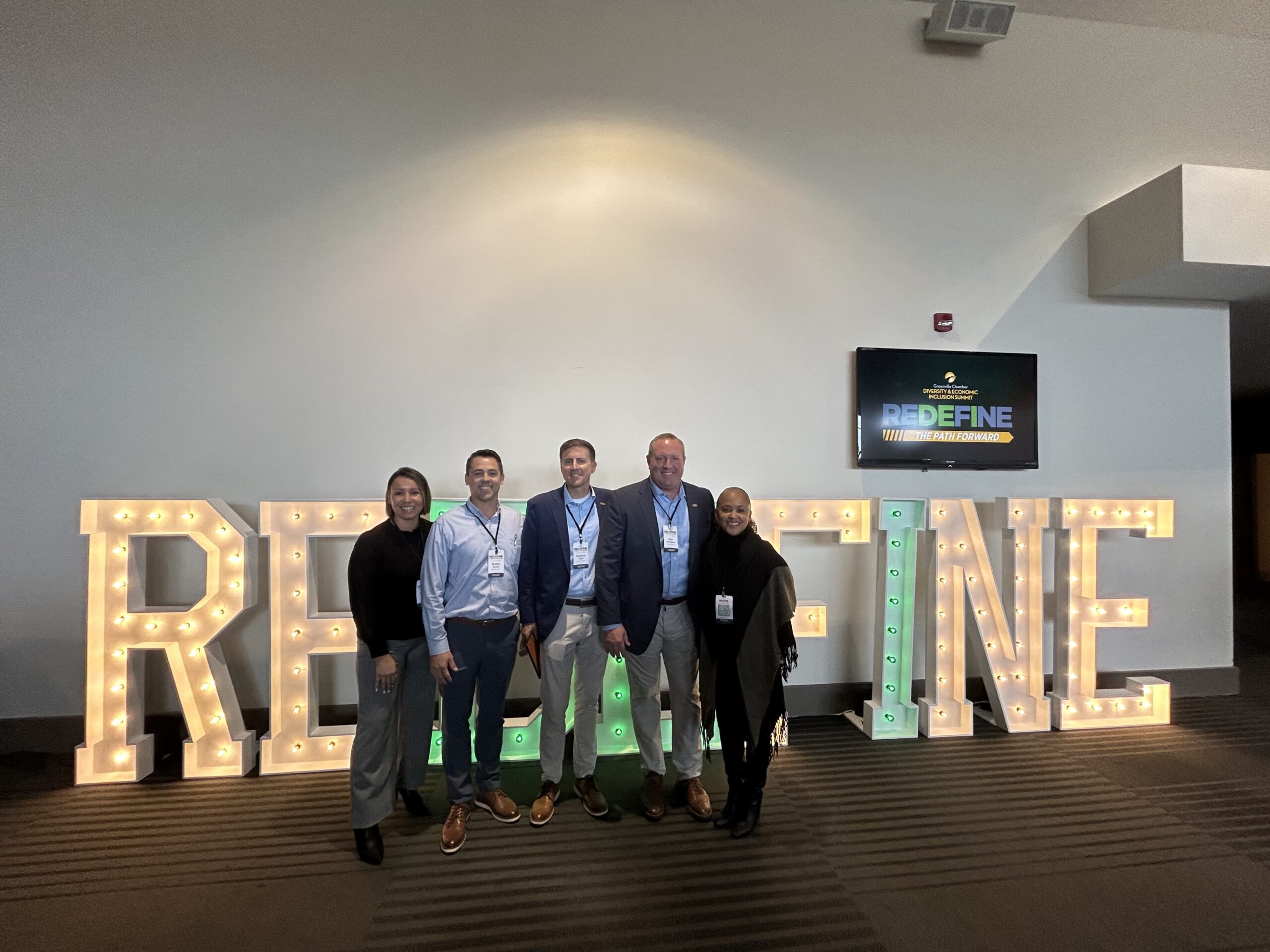 Messer Construction Company employees standing in front of event signage