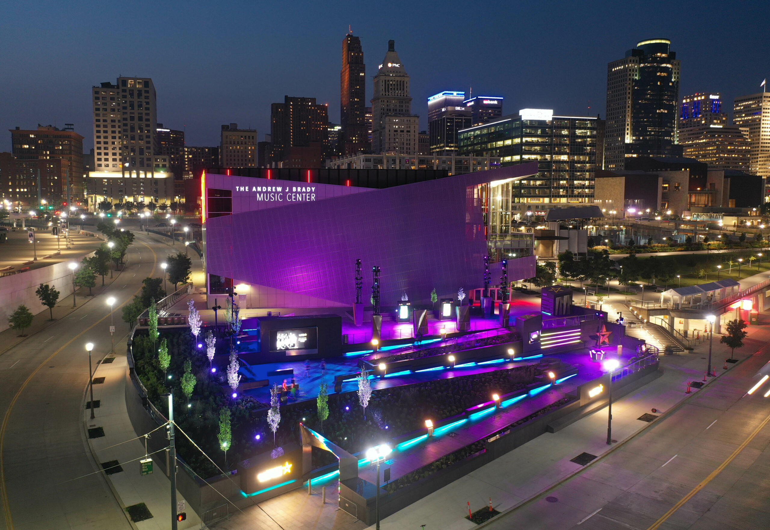 Outdoor aerial of the Cincinnati Black Music Walk of Fame lit up at night in purple and blue hues